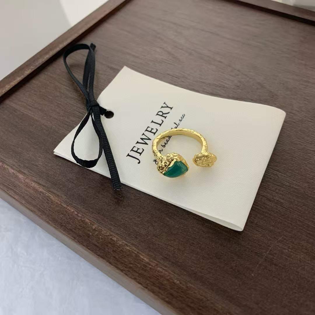Gold-Toned Ring with a Green Gemstone