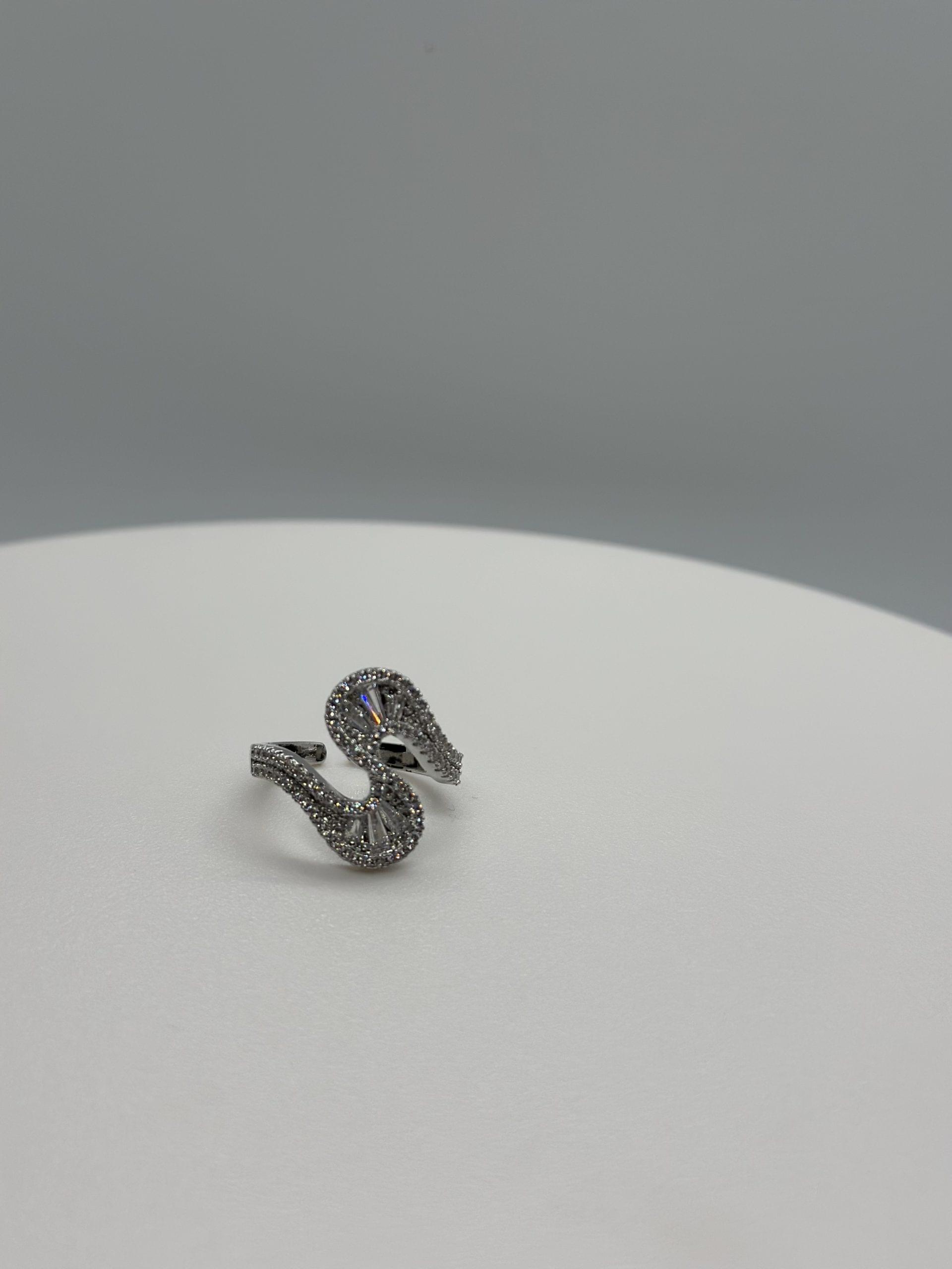 S-Shaped Ring Featuring Multiple Baguette And Round Cut Stones